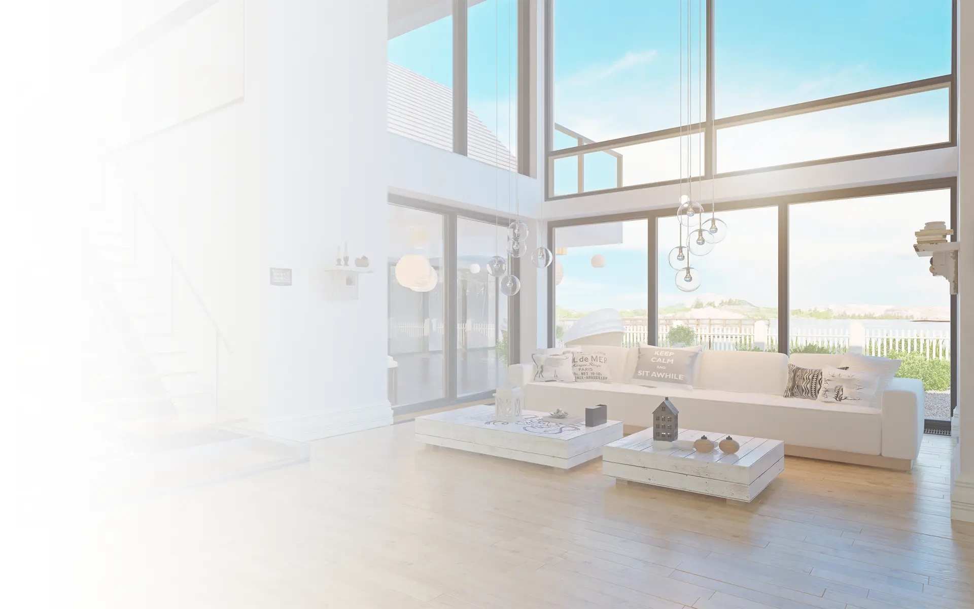 A living room of a house with a big white sofa, and two white tables.