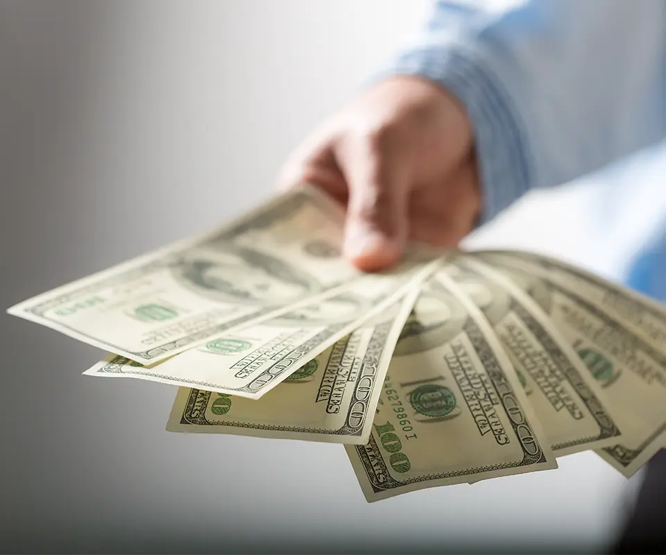 A man holding some dollars